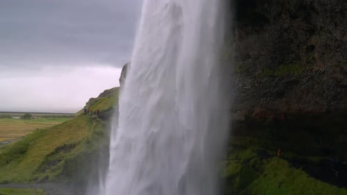 Water Flows in a Powerful Stream Down the Waterfall
