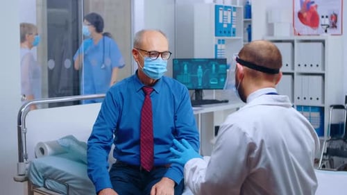Doctor Consults Patient in Bright Hospital Room