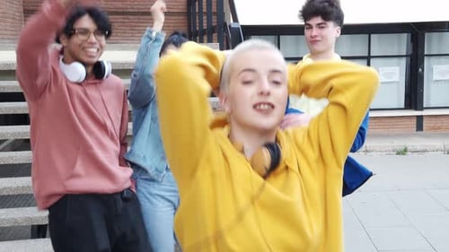 Group of Young Millennials Dancing Happily in a City