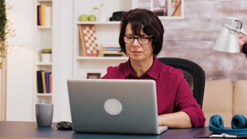 Woman working on laptop at desk