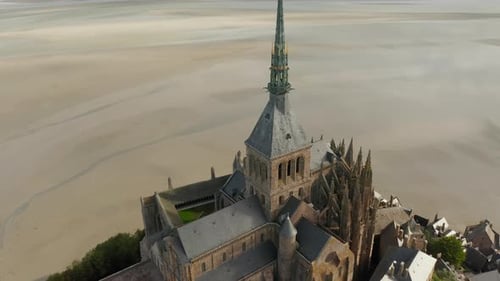 Mont Saint Michel Castle Top Big Cathedral Build in Ocean in France, Aerial Tilt Down