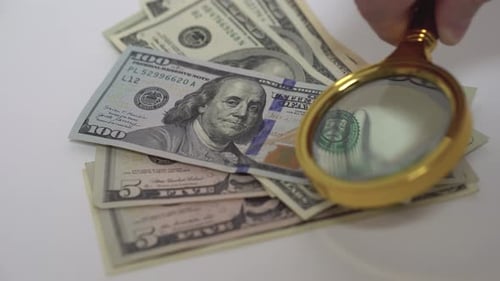 Magnifying Glass over United States Currency