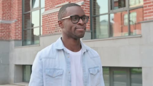 Close Up of Smiling African Man Walking in Street Side Pose