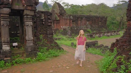 A Young Woman Tourist Is Walking Through Ruins in the My Son Sanctuary Remains of an Ancient Cham