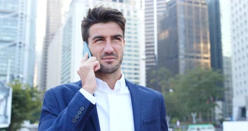 Man Talking on Phone in Urban Setting