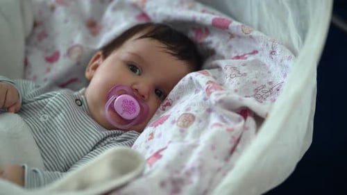 Infant Lying Comfortably in a Baby Bassinet