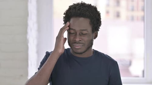 Portrait of Tired African Man Having Headache in Office