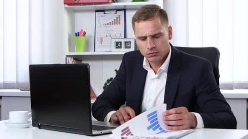 Young Man Working on Laptop in Urban Office
