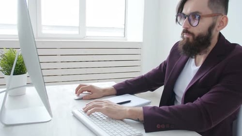 Concept of Freelancing and Office Work. Young Male Office Worker in the Workplace
