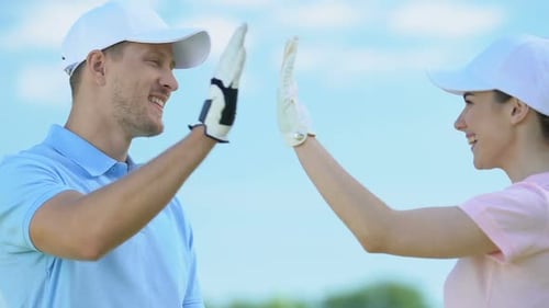 Woman and Man High Five While Golfing