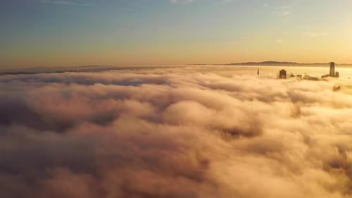 City Skyline Emerging from Golden Morning Clouds