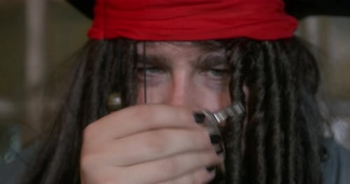Pirate with Dreadlocks Holds Up A Key