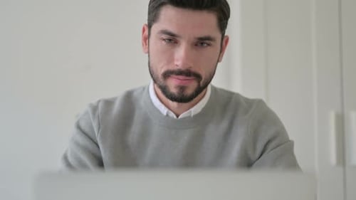 Close Up of Man Showing Thumbs Up While Using Laptop