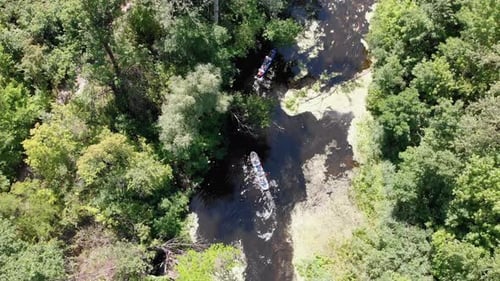 Kayaking and Canoeing Along the Riverbed Aerial View. Rafting. Tracking a Boat