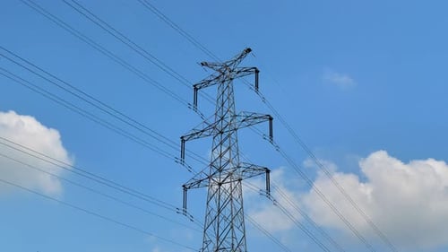 Electrical Tower Transmitting Energy With Cloudy Blue Sky