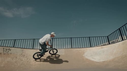 Young Adult Riding BMX Bike in Skatepark