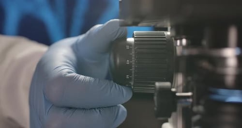 Hand Adjusts Lab Equipment