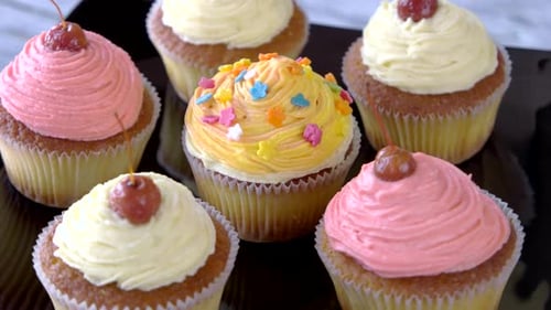 Delicious Cupcakes with Colorful Frosting Rotating