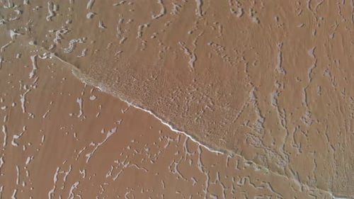 AERIAL DIRECTLY ABOVE Ocean Waves Rolling Into Shore