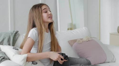 Girl Excitedly Playing Video Games on Couch