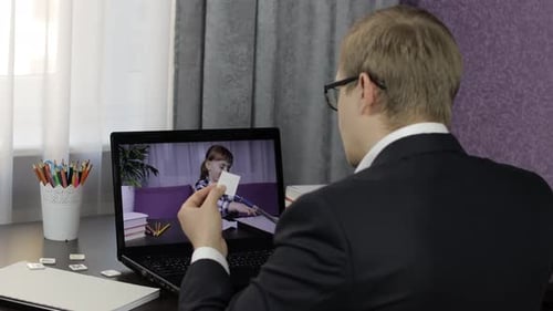Man Teaching Child Online Through Video Call