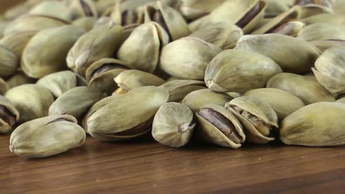 Pile of Pistachios Close-Up on Wooden Surface