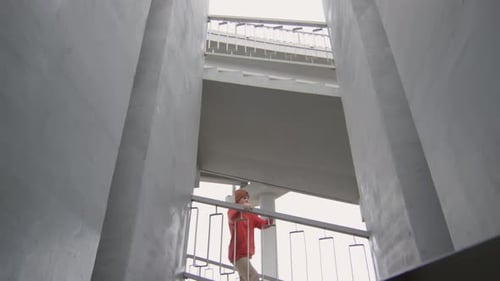 Young Adult Performs Parkour Tricks in Stairwell