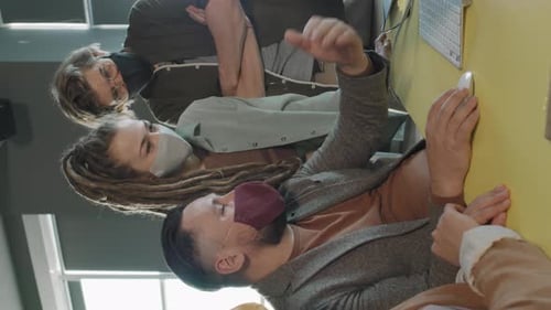 Coworkers Collaborating on Computer with Face Masks