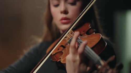 Young Woman Fiddler is Playing Violin in Philharmonic Hall Closeup Portrait of Female Violinist