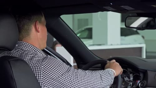 Man Gives Thumbs Up in Car Dealership