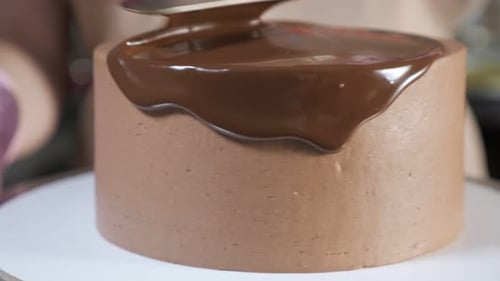 Chocolate Cake Ganache Decoration Being Applied Smoothly