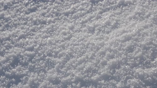 Milky white snow crystals close-up slow pan 4K 2160p 30fps UltraHD footage - Shallow DOF sparkling