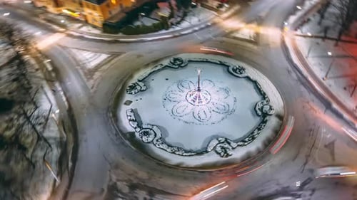 Aerial View Night Timelapse of Roundabout Road with Circular Cars in Small European City