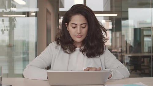 Woman Working at Computer in Modern Office