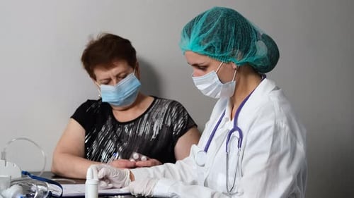 Doctor Consults Patient During Medical Examination