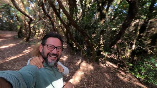 Happy adult couple enjoy together outdoor leisure activity in the forest