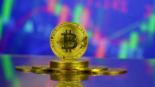 Bitcoin Coins Stacked with Financial Chart Background