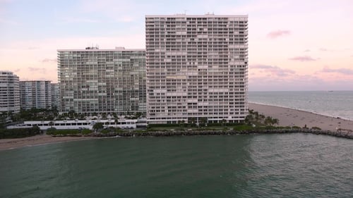 A cruise ship goes to the open sea from the seaport of a large city
