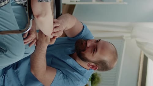 Healthcare Worker Assists Senior with Arm Exercises