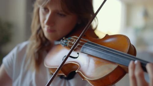 Woman Playing Violin in Home Interior