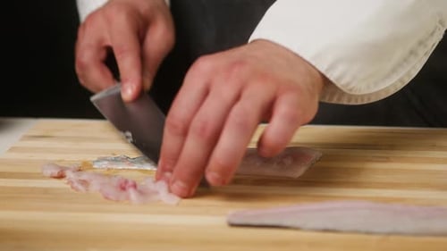 Chef Cuts Fresh Fish Fillet on Cutting Board
