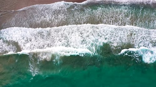 Aerial View of the Mediterranean Coast Waves Reach the Deserted Sandy Beach