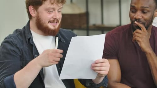 Two Men Discussing Business Plans on Couch