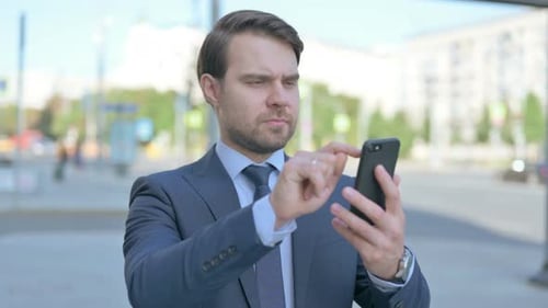 Man Using Smart Phone in Urban Setting