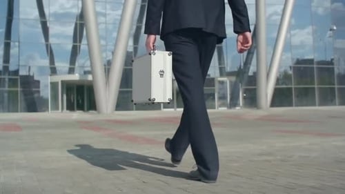 Man with Money Case Walking Outside