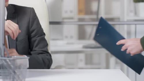 Business Handshake Between Man and Woman in Office