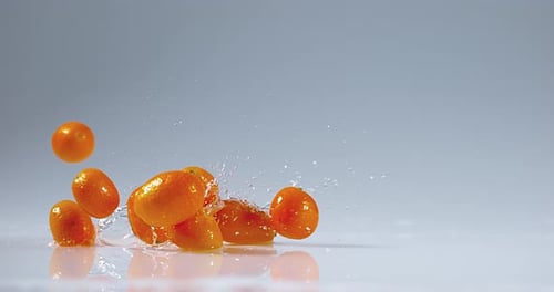 Kumquat, fortunella margarita, Fruits falling on Water, Slow motion 4K