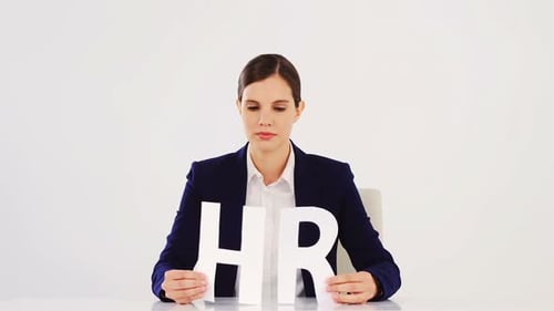 Smiling Woman Holding HR Letters in Office
