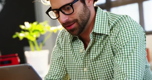 Young Adult With Tablet in Creative Workplace