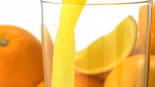 Orange Juice Being Poured Into Glass With Slices